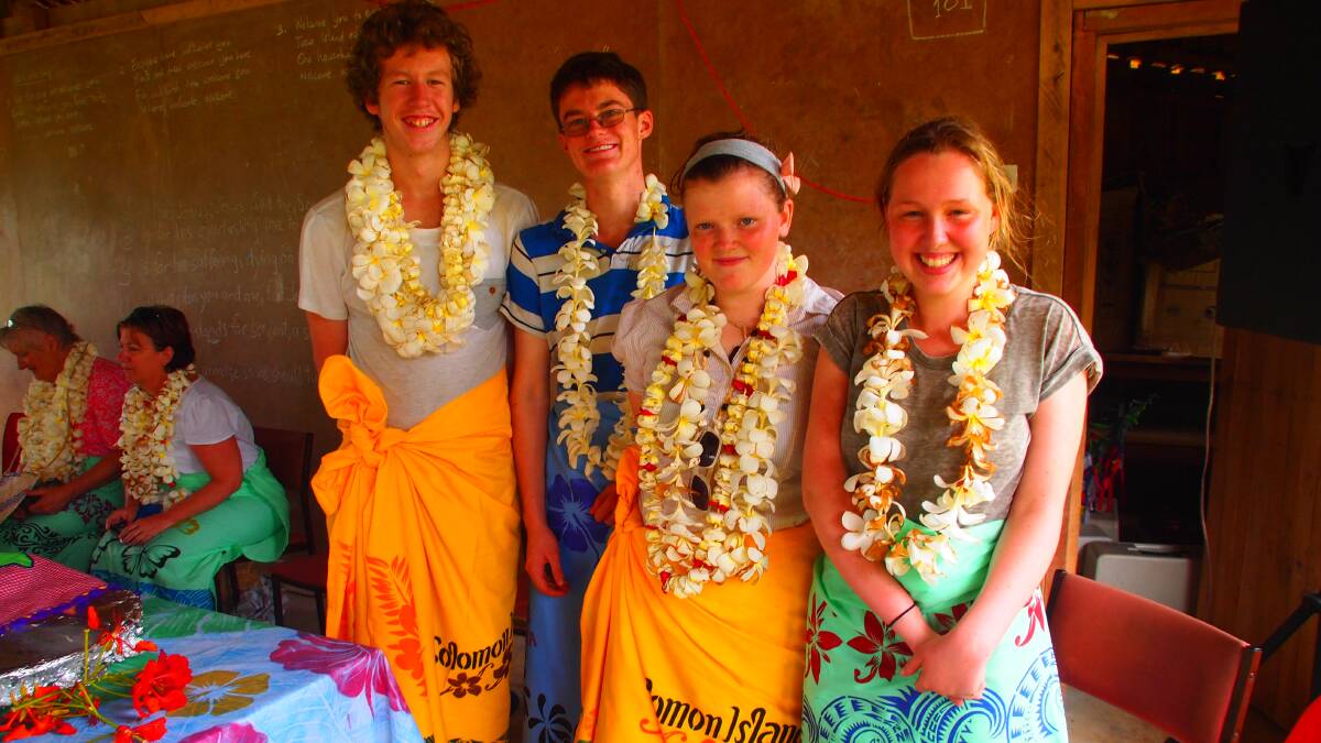 CHRISTIAN CULTURAL EXPERIENCE: Orange Anglican Grammar School students Joshua Dunnett, Will Christie, Bethany Mitchell and Georgia Balcomb tried on some tropical-style clothing and lived and ate with the locals during a stay in the Solomon Islands recently. Photo: SUPPLIED