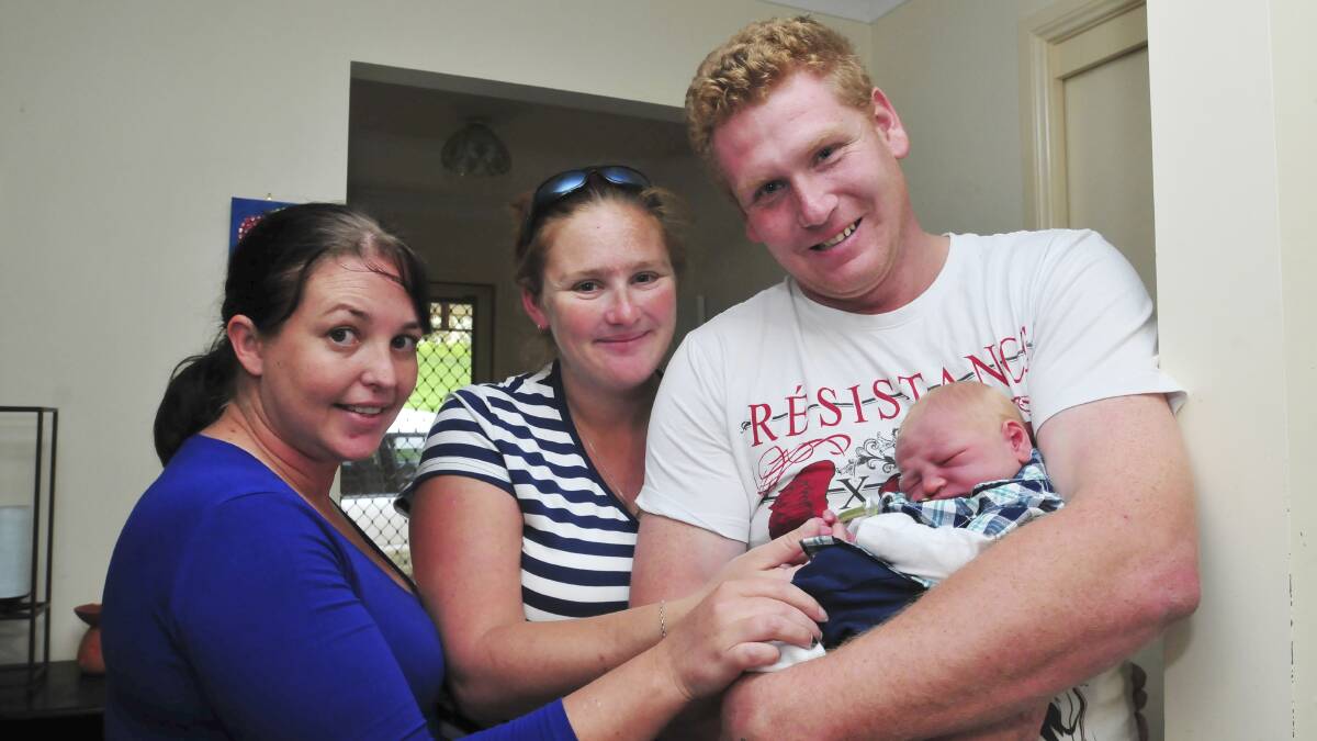 TINY SURPRISE: Rochell Watts (centre) gave birth to a healthy baby boy in her friend’s car outside Orange hospital on Wednesday. She and Hunter are pictured with godmother Natalie Palazzi and dad David Hayward. Photo: JUDE KEOGH 													                 0410baby2
