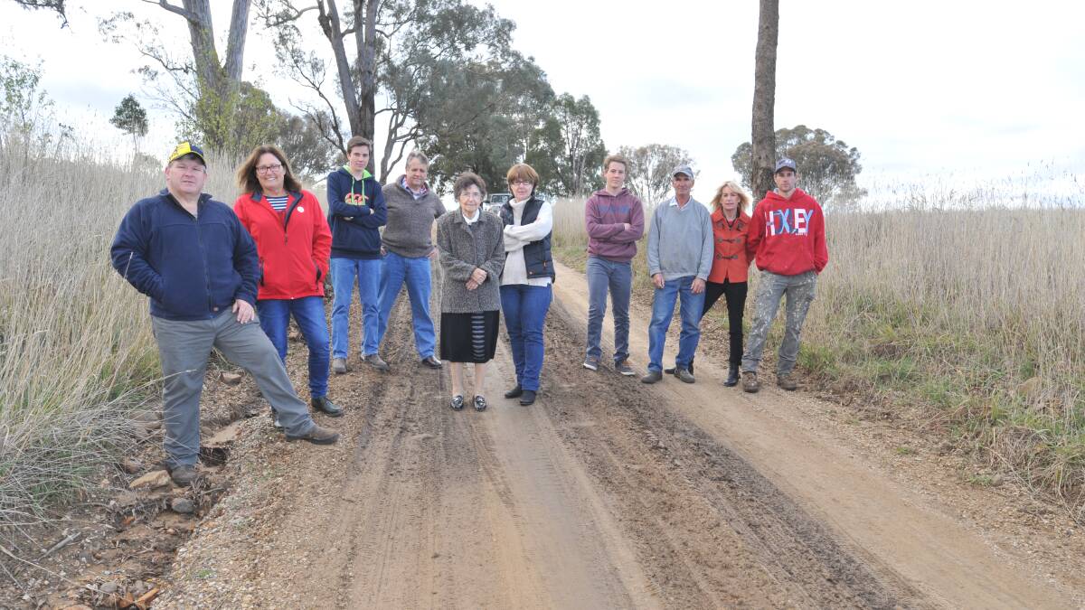 ROAD TO RUIN: David and Hilda Tovey, Angus and Roger Eddy, Val McDonald, Gail and Mitchel Eddy, Andrew, Lynette and Jared McDonald are not happy with the condition of McDonald Road. Photo: JUDE KEOGH