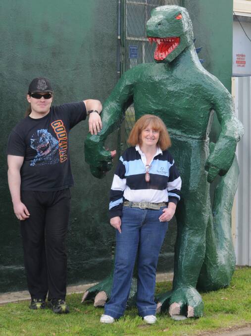 MONSTER MODEL: Luke and his mum Jennifer Rout with the eight foot Godzilla monster Luke built. Photo: STEVE GOSCH  0428sggodzilla1