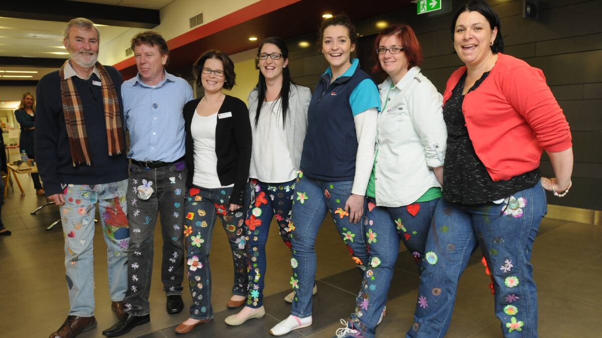 COLOURFUL JEANS: Orange hospital staff wore their jeans yesterday to help raise funds for research into children’s diseases through Jeans for Genes. From left John Burns, Michael Fitzgerald-Ryan, Lisa Simpson, Louise Hawke, Natalie Carthew, Sandra Wicks and Naomi Lavery. Photo: STEVE GOSCH 0801jeans1