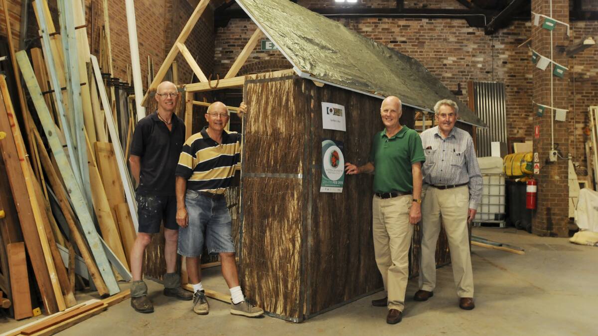 RUSTIC ATTRACTION: John Spanjer of The Busy Bees has built a hut for the Banjo Paterson Australian Poetry Festival with help from the festival’s committee chairman Len Banks, Cr Neil Jones and committee member and Rotary Club of Orange member David Williams. Photo: JUDE KEOGH 0106benjohut2
