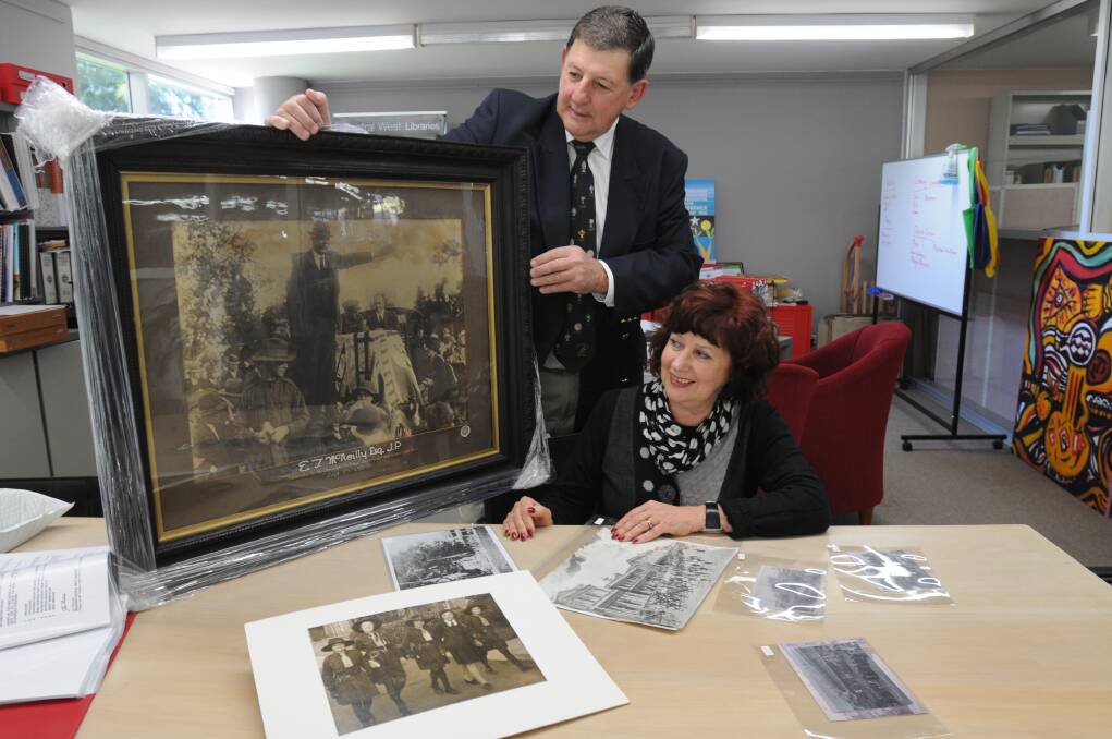 MARCHING ON: World War I Centenary working party chair Reg Kidd and Central West Libraries manager Jan Richards have called for residents to contribute Anzac march photographs for next year's commemorations. Cr Kidd shows off a photo of Mayor McNeilley on Anzac Day in 1925.
Photo: Steve Gosch.0512sgwarpics2