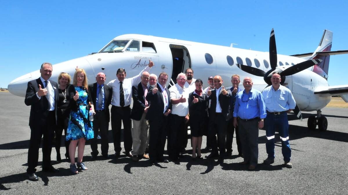 FLYING HIGH: Paul Cox, Rhonda Sear, Melanie McLaughlin, Tony Healy, Reg Kidd, Neil Jones, Ron Gander, James Blake, John Davis, Garry Styles, Natalie Costa, Phil Robertson, Fabrice Binet, Kel Gardiner, Chris Gryllis and Craig Hort give the thumbs up to Brindabella at the airline’s launch in December 2012. Orange City Council has all but given up hope of recovering almost $43,000 in passenger fees owed by the failed airline. Photo: JUDE KEOGH 		                1218brin2