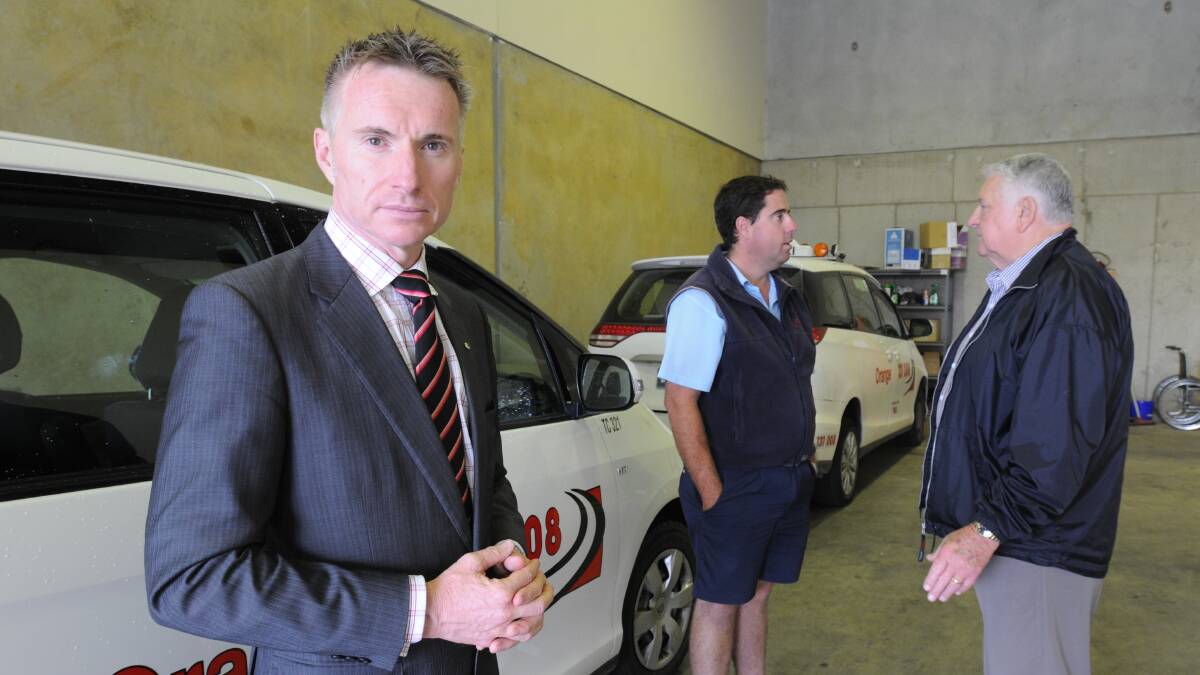 TOUGH TIMES: NSW Taxi Council chief executive officer Roy Wakelin-King, Orange Taxis chairman Darryl Curran and NSW Country Taxi Operators Association president Brian Wilkins met in Orange this week to talk about challenges facing the industry. Photo: STVE GOSCH  0326sgtaxi21