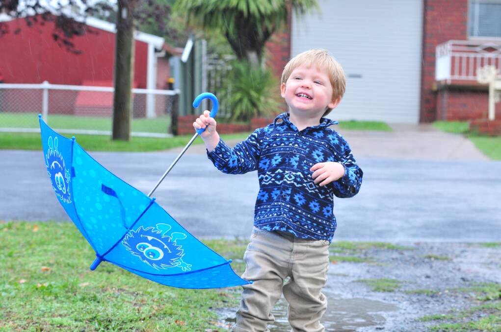 WET AND WILD: Summer came to a watery end yesterday and little Aiden Ford took the opportunity to play in the puddles. Photo: JUDE KEOGH 0228rain3