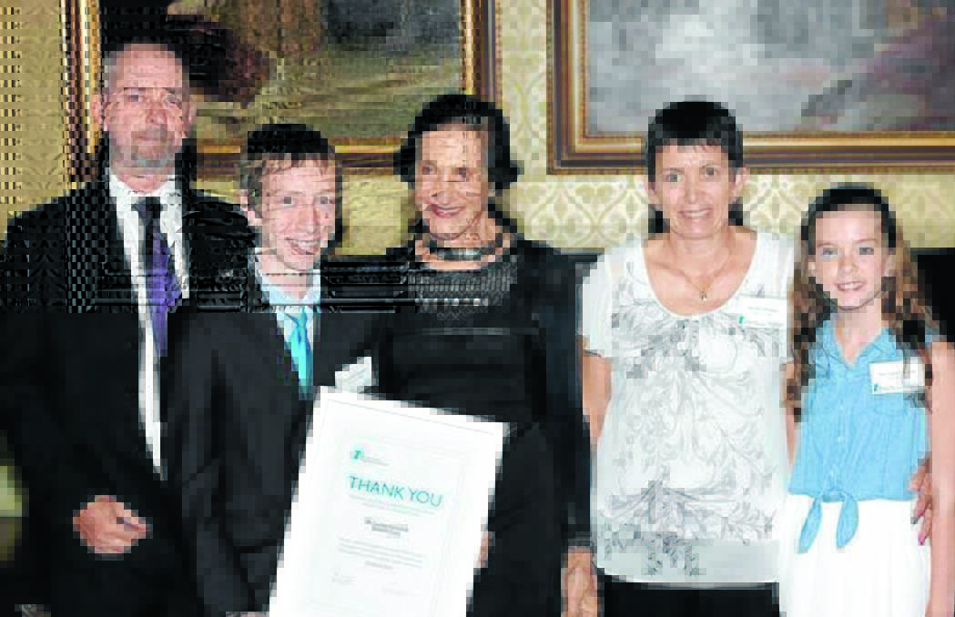 INSPIRATION: Lachlan Campbell (second from left), pictured with his family and Governor Marie Bashir (centre).