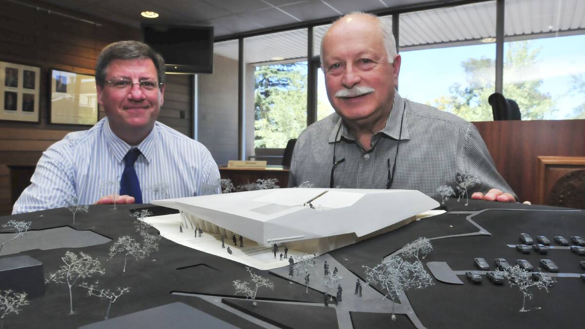 BUDGET SKYROCKETS: The Southern Skies planetarium could be scaled down due to costs, but councillor Chris Gryllis (right), and Orange Planetarium president Rod Somerville believe there will be a positive outcome. Photo: JUDE KEOGH               0306planet4