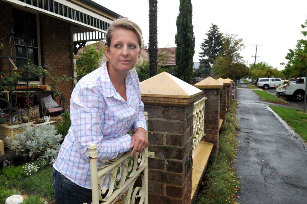 OFF LOAD: Edward Street resident Claire Lutkie is fed up with John Davis Motors unloading and loading cars in the street, which she believes breaches the business’ development conditions. Photo: STEVE GOSCH  0228sgcars1
