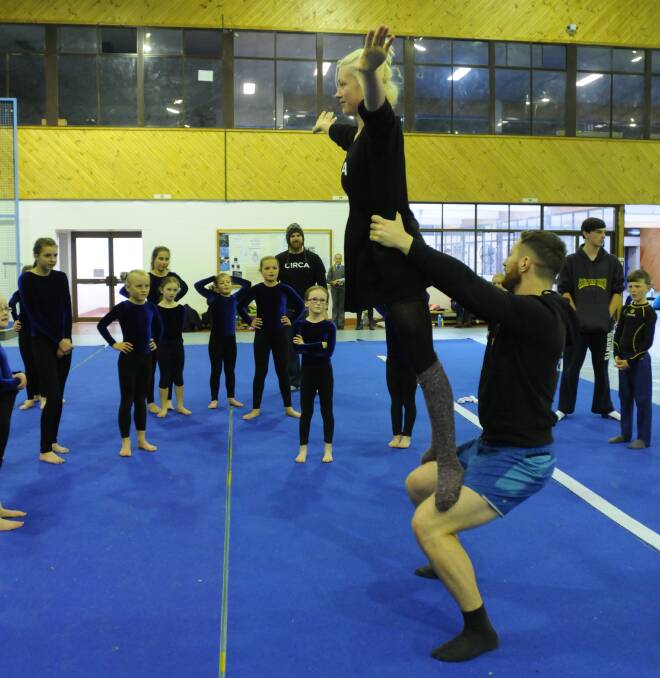 TOP OPPORTUNITY: Central West Gymnastics team members watch Circa Contemporary Circus’ Kimberley Rossi and Nathan Boyle perform during a workshop at Kinross Wolaroi School gym yesterday afternoon. Photo: STEVE GOSCH 0603sgcirca1
