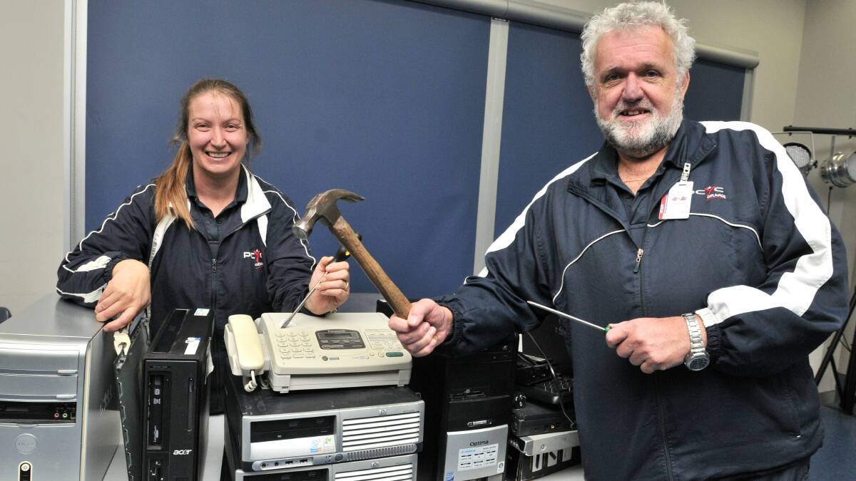 HOW DOES IT WORK: Orange PCYC senior activity officer Shaye Moss and assistant manager Dave Cleal are asking for donations of old appliances for their school holiday activity program, which begins on June 29.  Photo: STEVE GOSCH 					             0622sgpcyc2