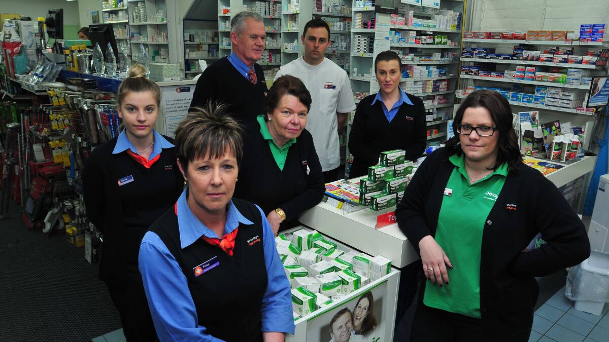 HARD TO BELIEVE: McCarthy’s Pharmacy staff are reeling from the theft of almost $800 raised for the Prostate Cancer Foundation of Australia. Pictured are (back) Michael McCarthy and Nathan Wood, (centre) Corine Fahy, Donna Thornton and Kylie Ryan, and (front) Peita Whiley and Caitlin Haase. Photo: JUDE KEOGH								           0813mccarthys
