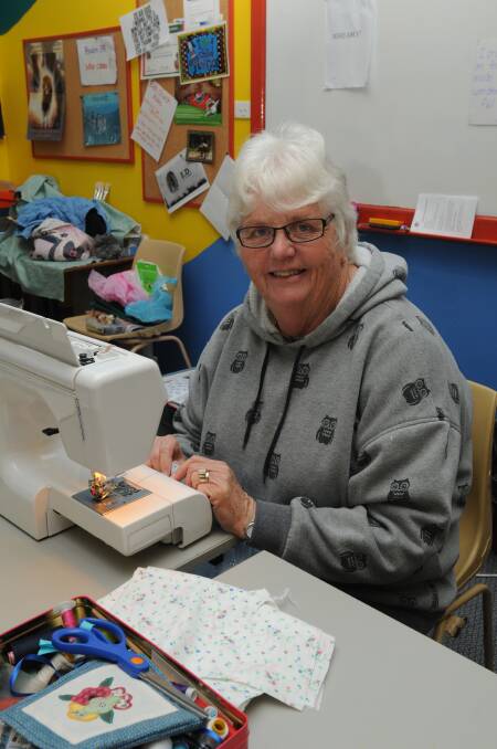 BUSY FINGERS: Elizabeth Kay sewed items for the Samaritan’s Purse Operation Christmas Child working bee on Saturday.                             0627christian1