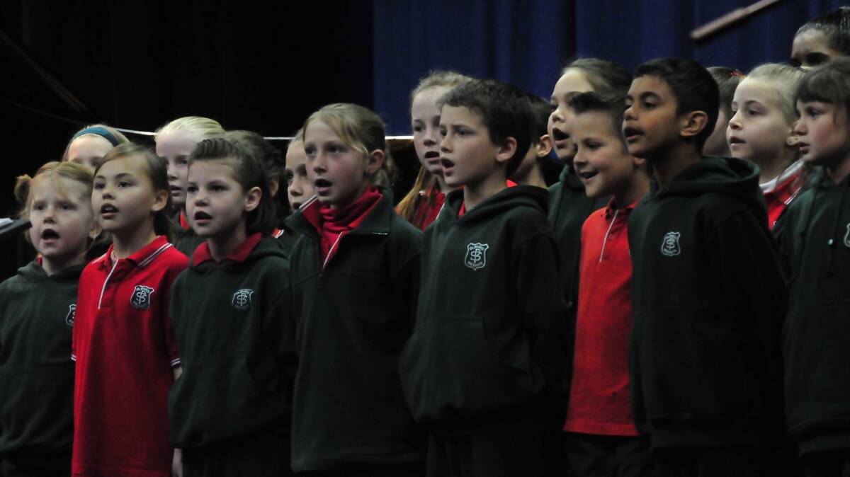 SINGING THEIR HEARTS OUT: Students from Glenroi Public School, conducted by Donna Riles, were complimented on their two pieces of music with an Aboriginal theme, performed at the Eisteddfod yesterday. Photos: JUDE KEOGH 		           	            0814eist1
