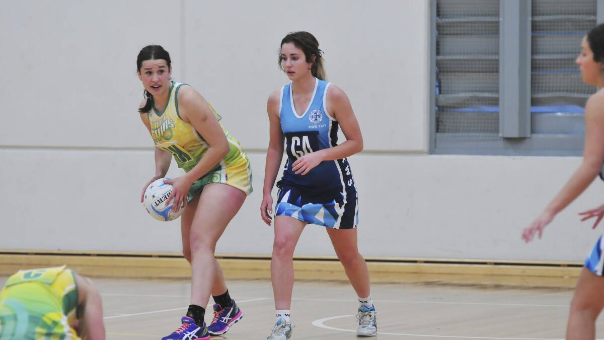 SUPPORT: Gladiators centre-court star Katie Matthews, pictured taking on KWS 1sts gun Nikki Collins, will play a crucial role for CYMS this weekend. Photo: JUDE KEOGH 0614netball5
