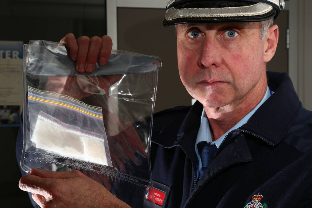 COLD HARD FACTS: Canobolas local area command Inspector Dave Harvey with a quantity of ice recently confiscated by Orange police. Photo: PHIL BLATCH 0603pbice6
