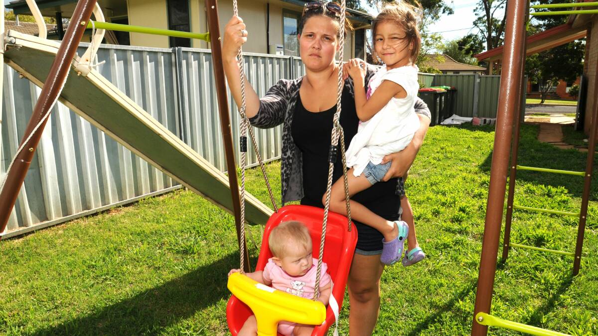 SHATTERED: Crystal Webb, with her  children Riley Firth and Sophia Oakes, is horrified someone could take away her independence after her car was stolen and destroyed on Thursday night. Photo: STEVE GOSCH    0321sgcar1