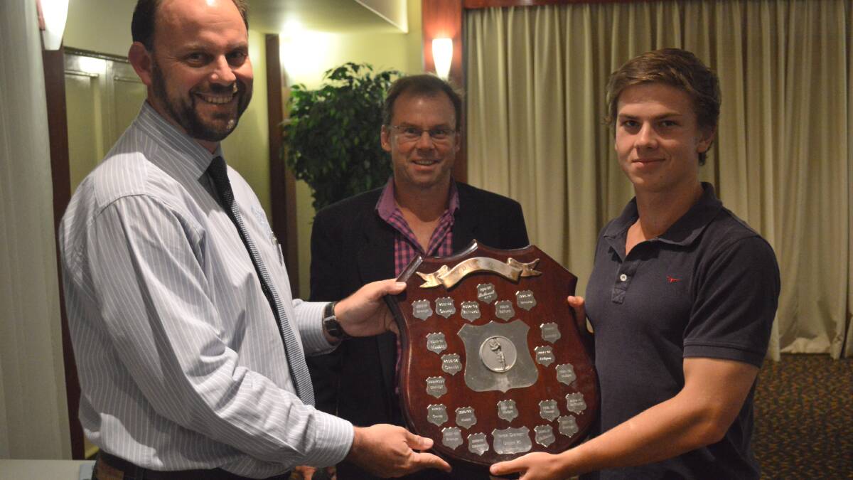 YOUNG GUNS: Orange all-rounder Sam Nicholls (right) and coach Andrew Litchfield (middle) accept the Mitchell under 21 shield from ODCA president Mark Frecklington (left). Photo: MATT FINDLAY 0326mfodca1