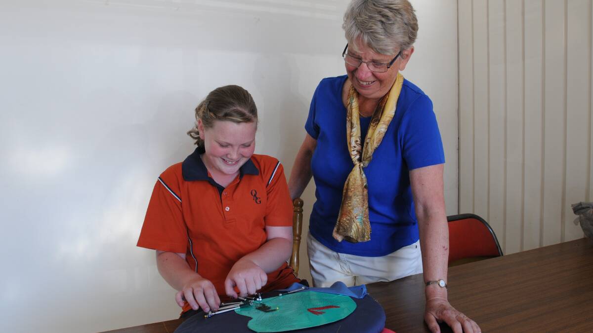 KEEPING UP TRADITION: Anya Skinner, 12, with Jean Primrose is the youngest member of the Orange Lace Makers. Photo: STEVE GOSCH 0325sglace2
