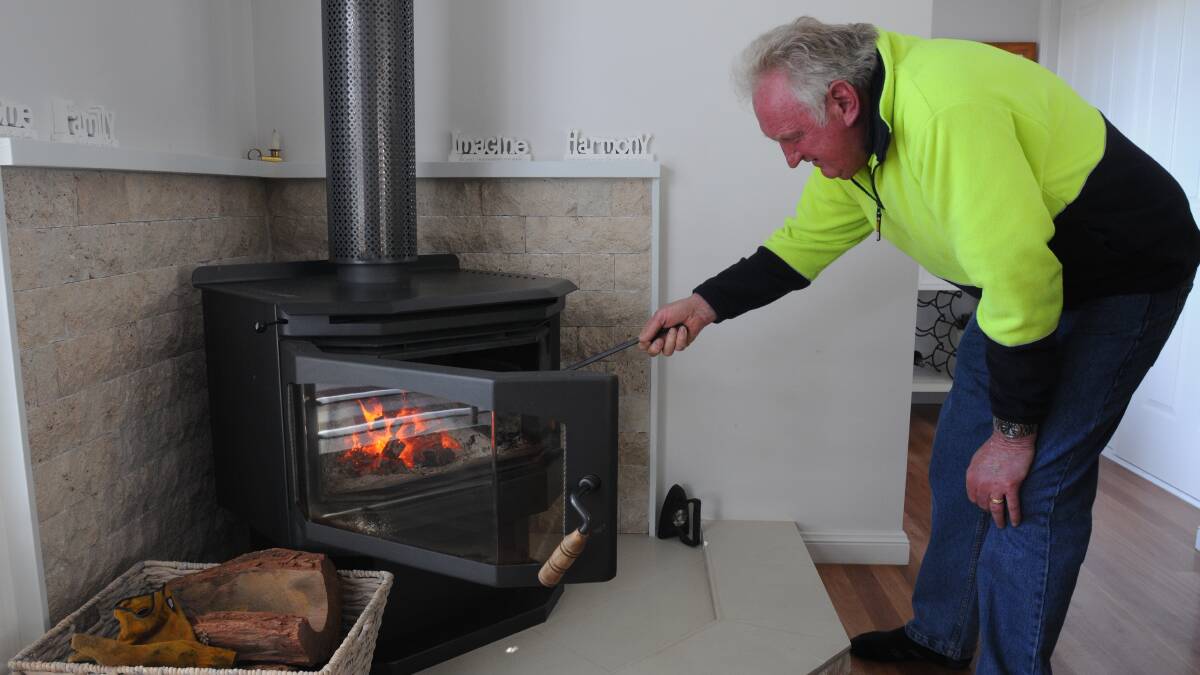 WOOD'S GOOD: Forest Reefs resident Bill Sovdat says his wood heater is cheap and clean. Photo: STEVE GOSCH 0828sgwood1