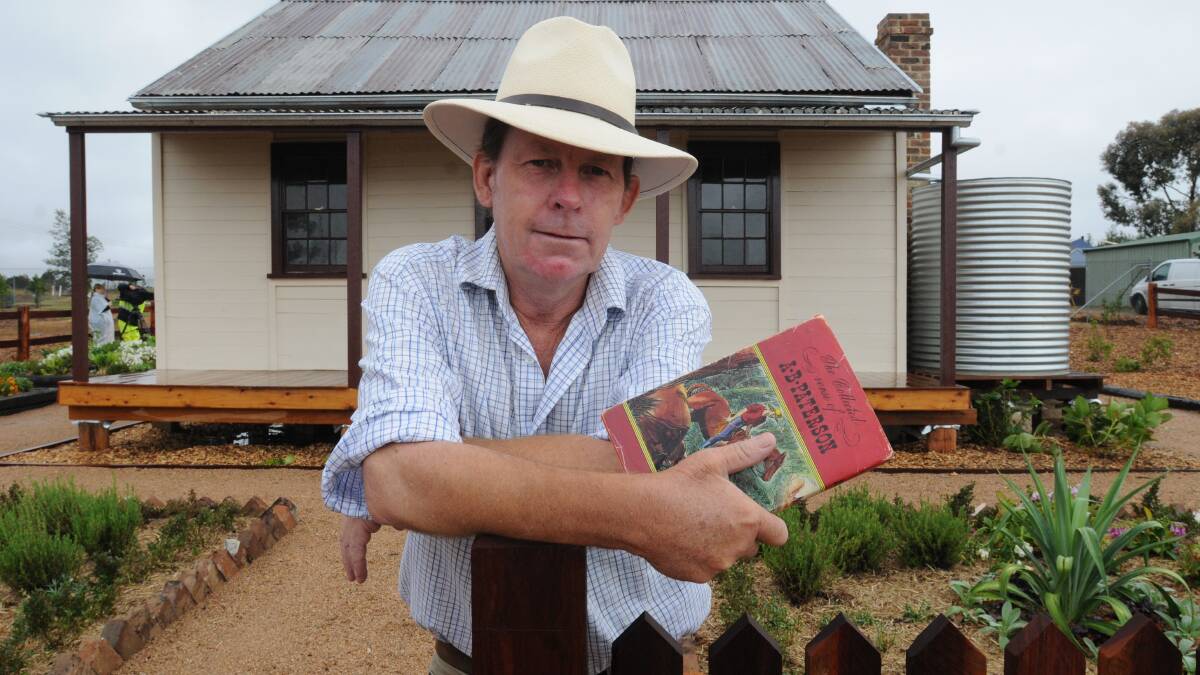 FAMILY STORY: Anthony Barton may be a distant relative of Banjo Paterson, but he has some doubts about Emmaville Cottage. He is pictured with a book of Banjo’s poems he received from his parents when he was eight years old. Photo: STEVE GOSCH  0216sgbarton
