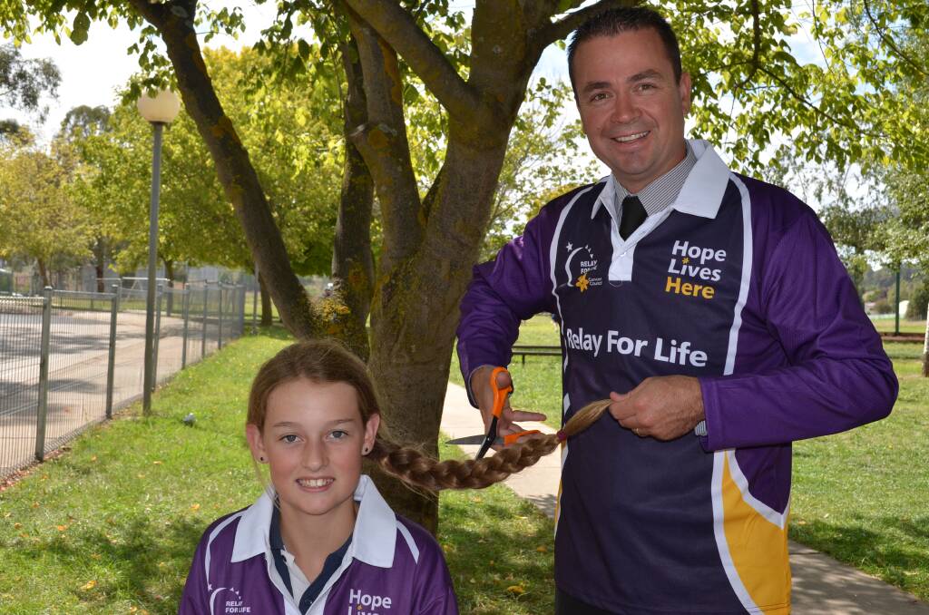 HAIRCUT FOR A CAUSE: St Mary’s Catholic Primary School student Abigale Philpott,11 is going to cut off her long locks and teacher Glenn Corben will have his legs waxed to raise money for the Relay for Life next month. Photo: TANYA MARSCHKE                                                                                                              0213tmcut1.

