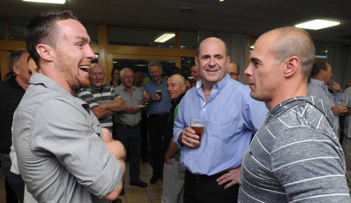 CATCH UP: Sydney Roosters and New South Wales star James Maloney (left) shares a joke with Ray Agland (centre) and Orange CYMS captain-coach Mick Sullivan on Saturday night. Photo: STEVE GOSCH