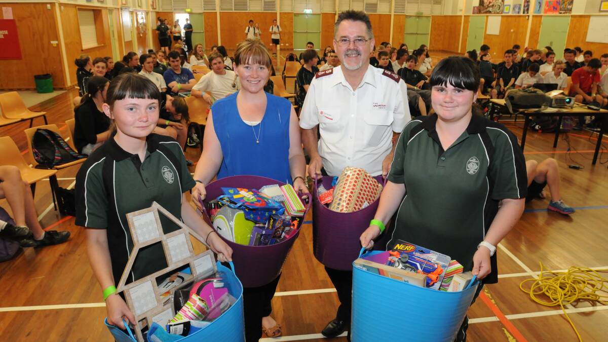 GIFT OF GIVING: Canobolas Rural Technology High School student Kirsty Eyles, teacher Jemma Kenneally, Salvation Army Major Greg Saunders and student Brittany Eyles with gifts the school will donate to the Kmart Wishing Tree Appeal. Photo: JUDE KEOGH   1216canobsalvos