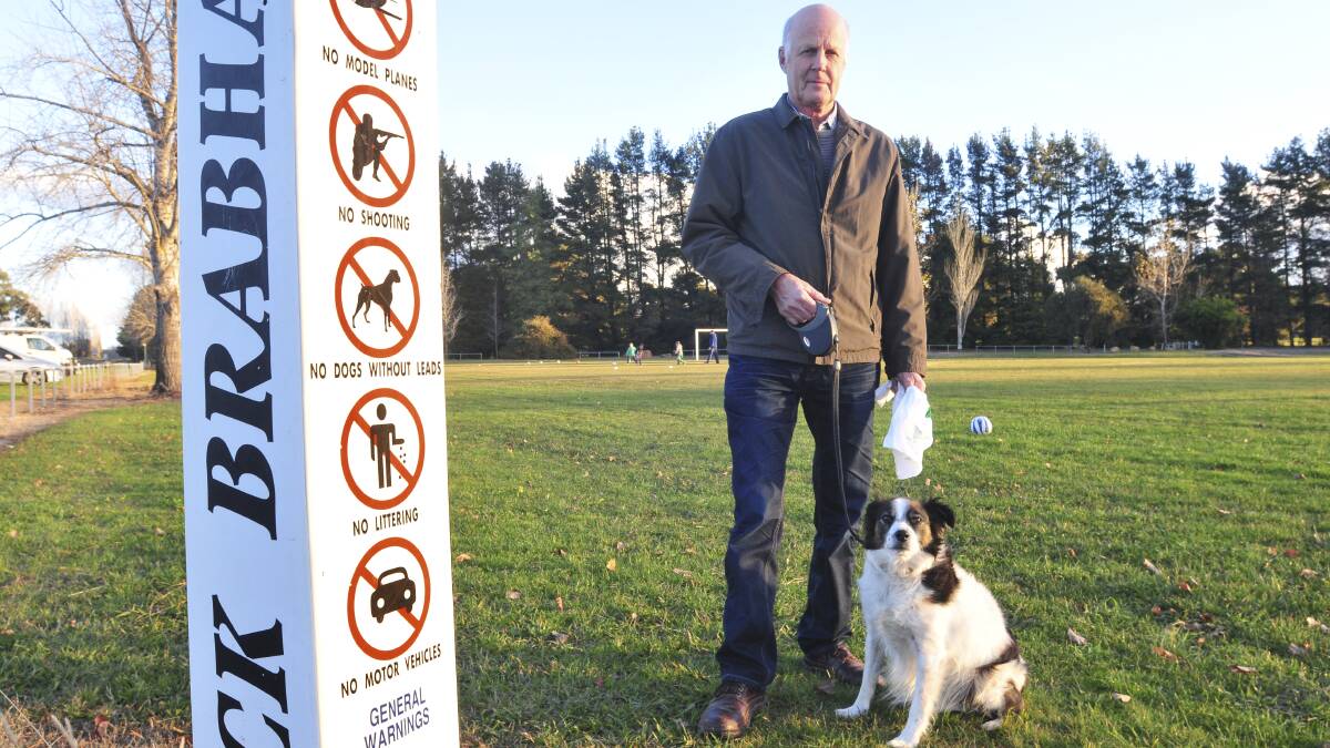 DO THE RIGHT THING: Orange City Council’s companion animal committee member councillor Neil Jones has warned people using Jack Brabham Park and other areas in the city they must pick up after their dogs and keep them on leashes or face hefty fines. Cr Jones is pictured with his loveable dog, Rex. Photo: JUDE KEOGH 0528brabham2