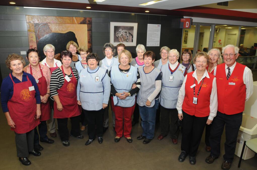 TAKE A BOW: Orange Hospital Auxilliary members (in red aprons from left) Evelyn Young, Corinne Stringer, Joy Wilkinson and  and Rosie Wells, Blue Ladies (blue aprons, from left) Libby Jones, Nancy Walsh,  Pam Bembrick, Lorraine Ashbrooke, Robyn Taylor, Jenny Ellem, Alison Hughes, Jenny Cashen, Shelly Gander, Dorothy Brown and Mary O’Hare,  and Wayfinders guides (red vests)  Bev Duncan, Joy Fabry and Norm Bembrick. Photo: STEVE GOSCH 0512sgvolunteers