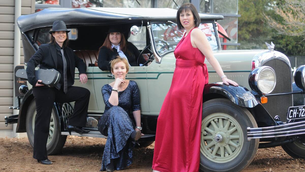 ON BOARD: Central Western Daily advertising manager Rochelle Monaghan and Ronald McDonald House committee members Nicole Pasquali, Rebecca Walsh and Kylie Lewis get into character for the Great Gatsby Ball with this 1928 Chrysler soft top. Photo: STEVE GOSCH 0815gatsby
