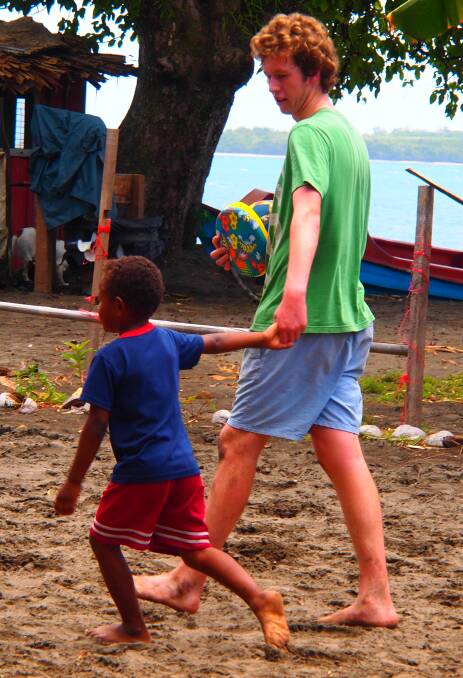 MAKING FRIENDS: Orange Anglican Grammar School student Joshua Dunnett enjoyed spending time with the local children during a visit by Orange Holy Trinity Anglican Church parishioners to the Solomon Islands. Photo: SUPPLIED