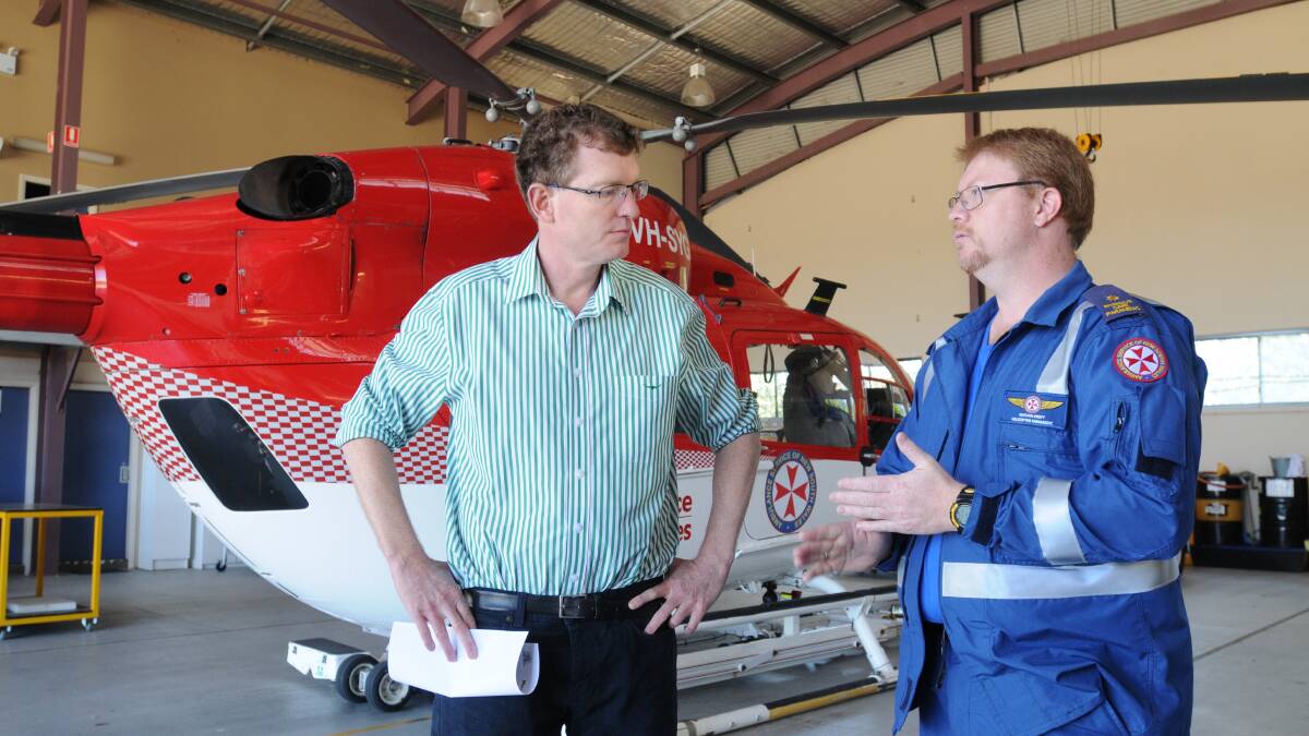 UPSIZING:  Member for Orange Andrew Gee and senior paramedic Nathan Croft discuss how a bigger helicopter will mean faster medical retrievals.
Photo: STEVE GOSCH 1219CHOPPER3

