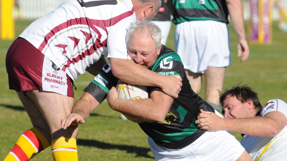 STILL GOT IT: CYMS stalwart Tony Ford is wrapped up by the Bears' defence in last year's Wade Park leg of the Michael Huck Hornby Memorial Trophy. Photo: JUDE KEOGH  0517oldboys3