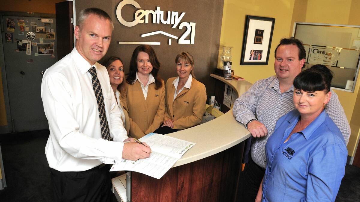 WE FIT: Century 21 Combined licensee Andrew Vogler fills out the health survey as staff Delina Kudrins, Karen O'Shaughnessy and Stephanie Giumelli and Pat Wilsmore of Insight Services Group and Octec's Donna Gosper look on. Photo: Steve Gosch 						0217sghealth