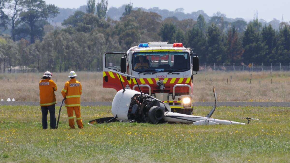 LUCKY ESCAPE: A woman and her flying instructor escaped serious injury when their helicopter crashed at Orange airport yesterday morning. Photos: OLIVIA SARGENT
