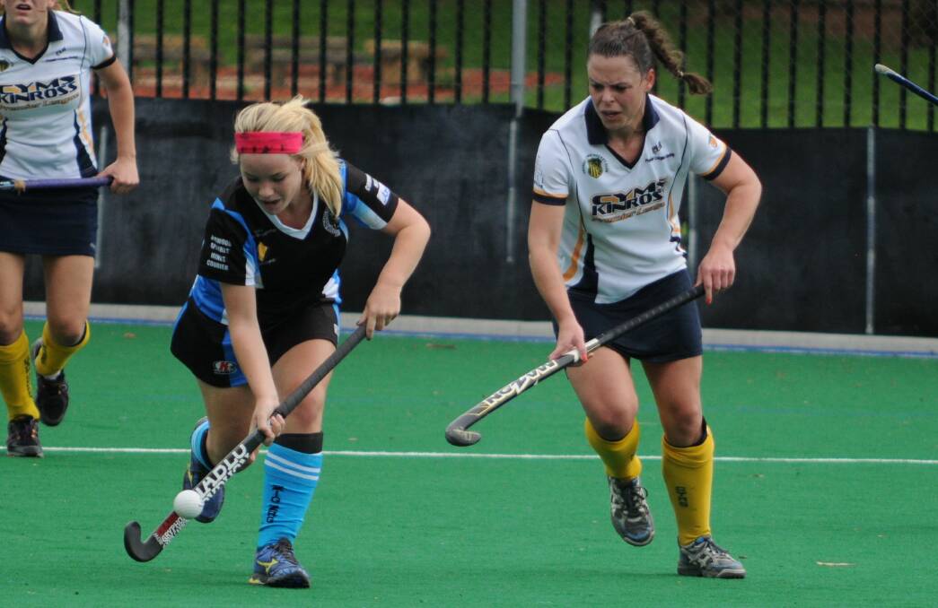 HOCKEY: Lithgow Zig Zag's Katie Wilkins keeps possession away from Kinross-CYMS' Amy Byrne at the Orange Hockey Centre on Saturday. Photo: STEVE GOSCH