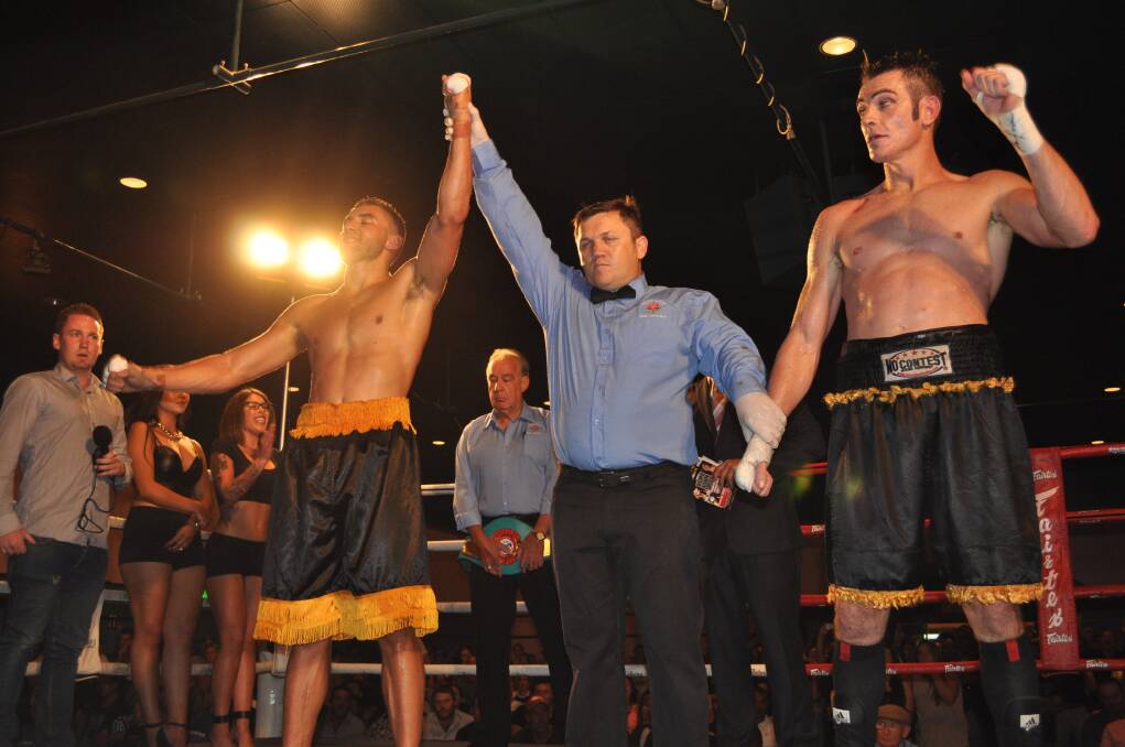 TO THE VICTOR GO THE SPOILS: Sam Ah-See (left) celebrates his Australian title win over Shannon 'Shaggy' King at the Orange Function Centre on Friday night. Photo: NICK MCGRATH