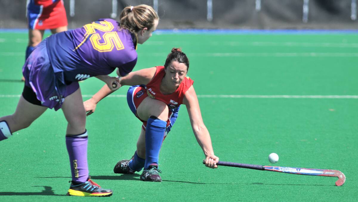 HOCKEY: Orange COnfederates Lucy Reinburger tries to stop a Lithgow Panthers attack on Saturday. Photo: STEVE GOSCH