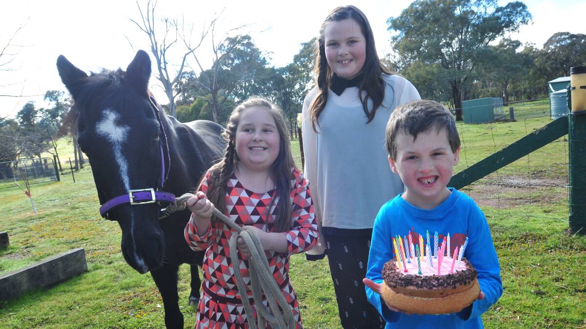 HAPPY BIRTHDAY BENNY: Charlotte Raffin with her new pony Benny, who is 10 today. She’s helping Benny celebrate along with her brother Jackson and friend Harriette Usher. Photo: MARK LOGAN 0727mlhorse1