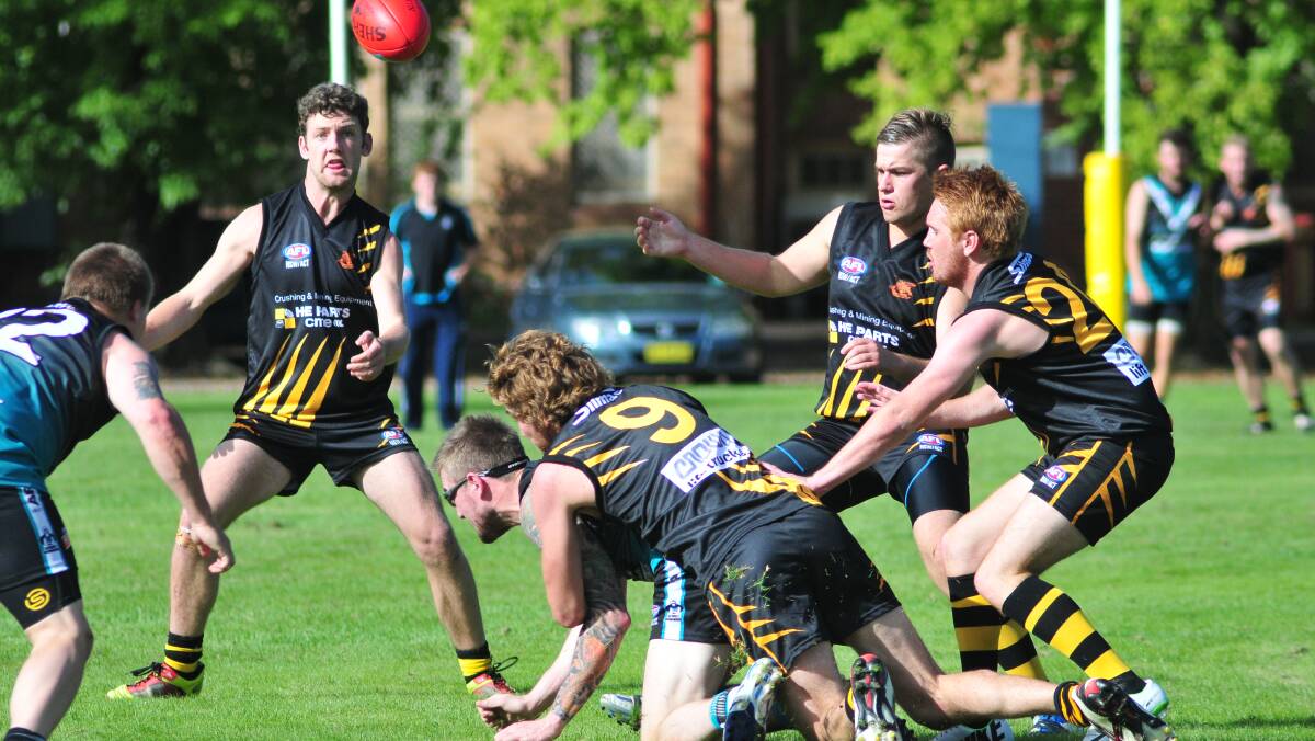CONTEST: Bathurst Bushrangers and Orange Tigers bplayers swarm on the ball on Saturday. Photo: JUDE KOEGH