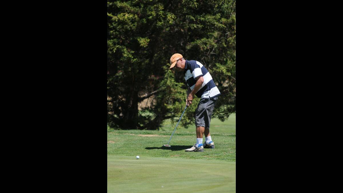 GOLF: John Sangster putting on to the green at the Country Club on Saturday. Photo: STEVE GOSCH