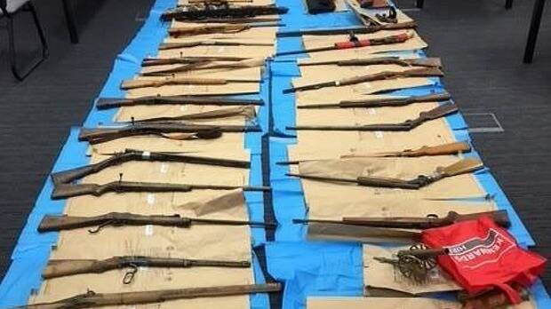 CACHE: The 28 firearms police discovered at a property near Forbes in central west NSW in April. Photo: NSW POLICE