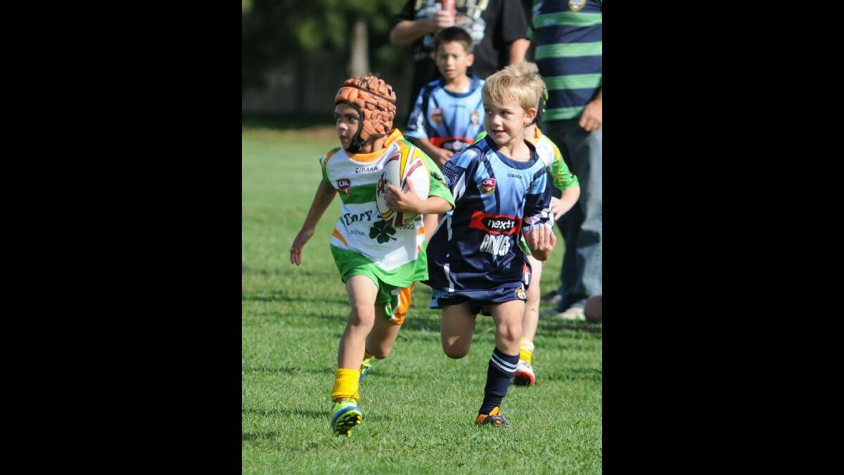RUGBY LEAGUE: CYMS Keegan Jones makes a run for it against Bloomfield in their under 7s game. Photo: STEVE GOSCH