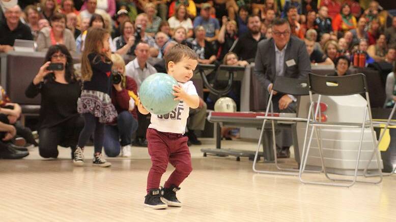 READY TO RELEASE: Hugo Belmonte about to show his dad Jason how it's done at Sydney's Tenpin City this week.