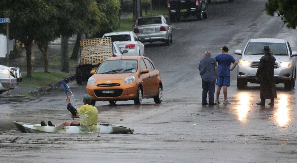 HIGH WATER: A man makes the most of the flash flooding in Orange in January. Photo: JUDE KEOGH