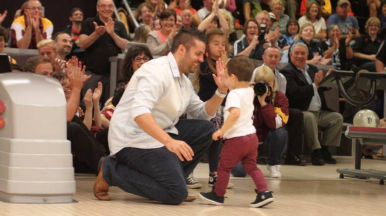HIGH FIVE: Jason Belmonte and son Hugo share a moment at Sydney's Tenpin City this week.