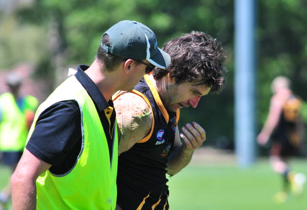 AUSSIE RULES: Josh Bubnich looks the worse for wear during the Orange Tigers' trial game on Saturday. Photo: JUDE KEOGH