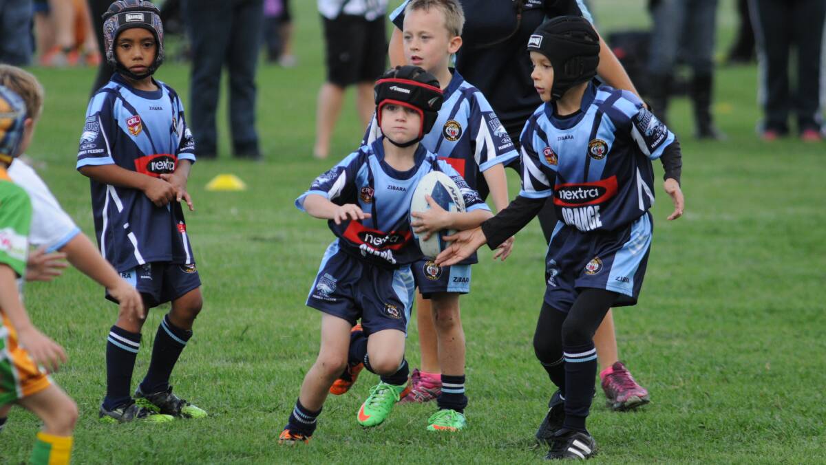 RUGBY LEAGUE: Bloomfield Tigers' Will Robinson is in no danger against the CYMS under 7s defence. Photo: STEVE GOSCH