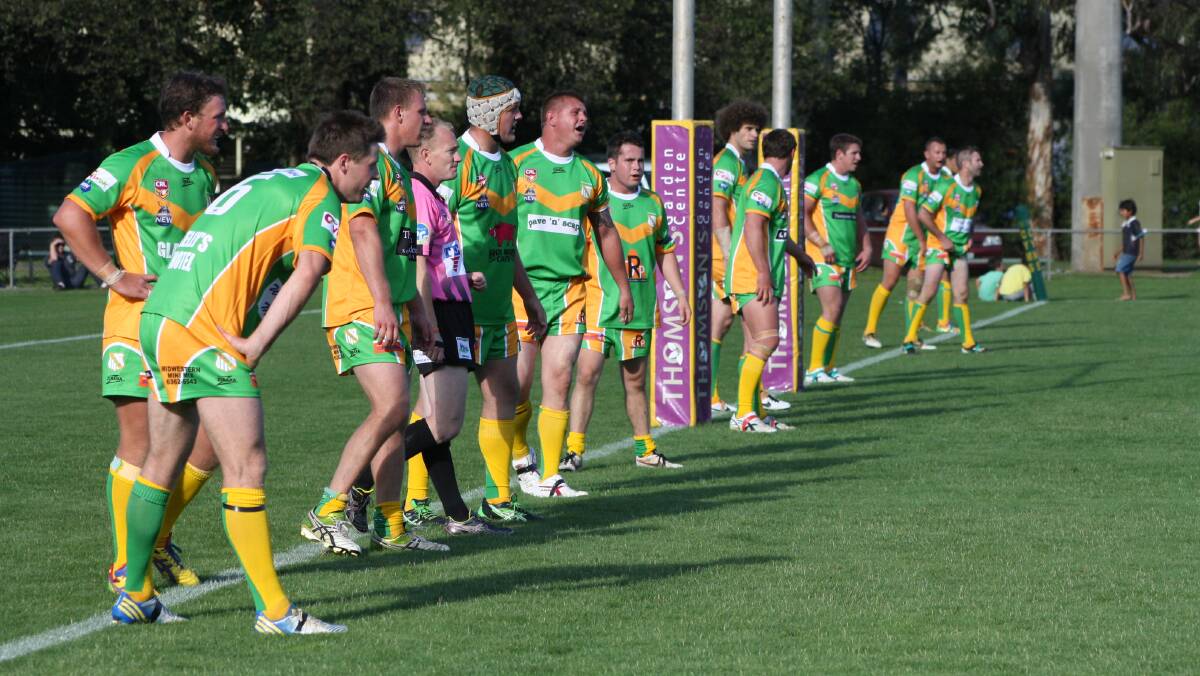 ORANGE CYMS: The green and golds prepare to defend their line against another Hawks raid. Photo: MICHELLE COOK